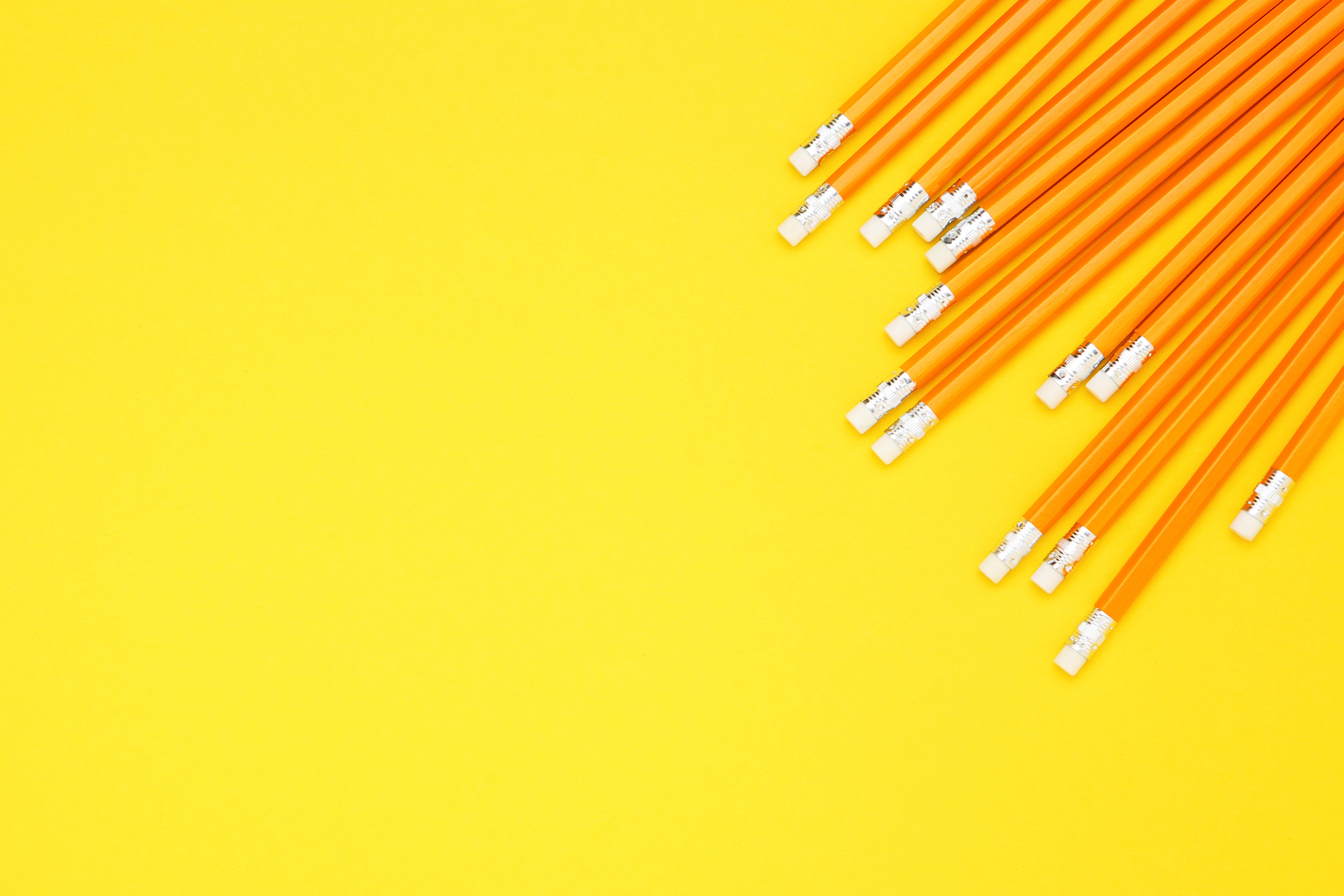 Yellow pencils on yellow background